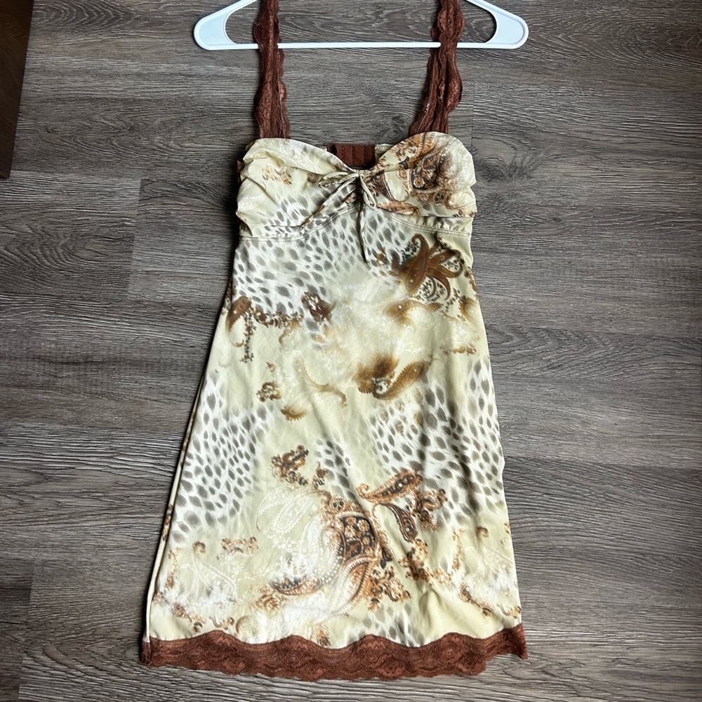 Brown and yellow leopard print mini dress with lace trim and bow detail.